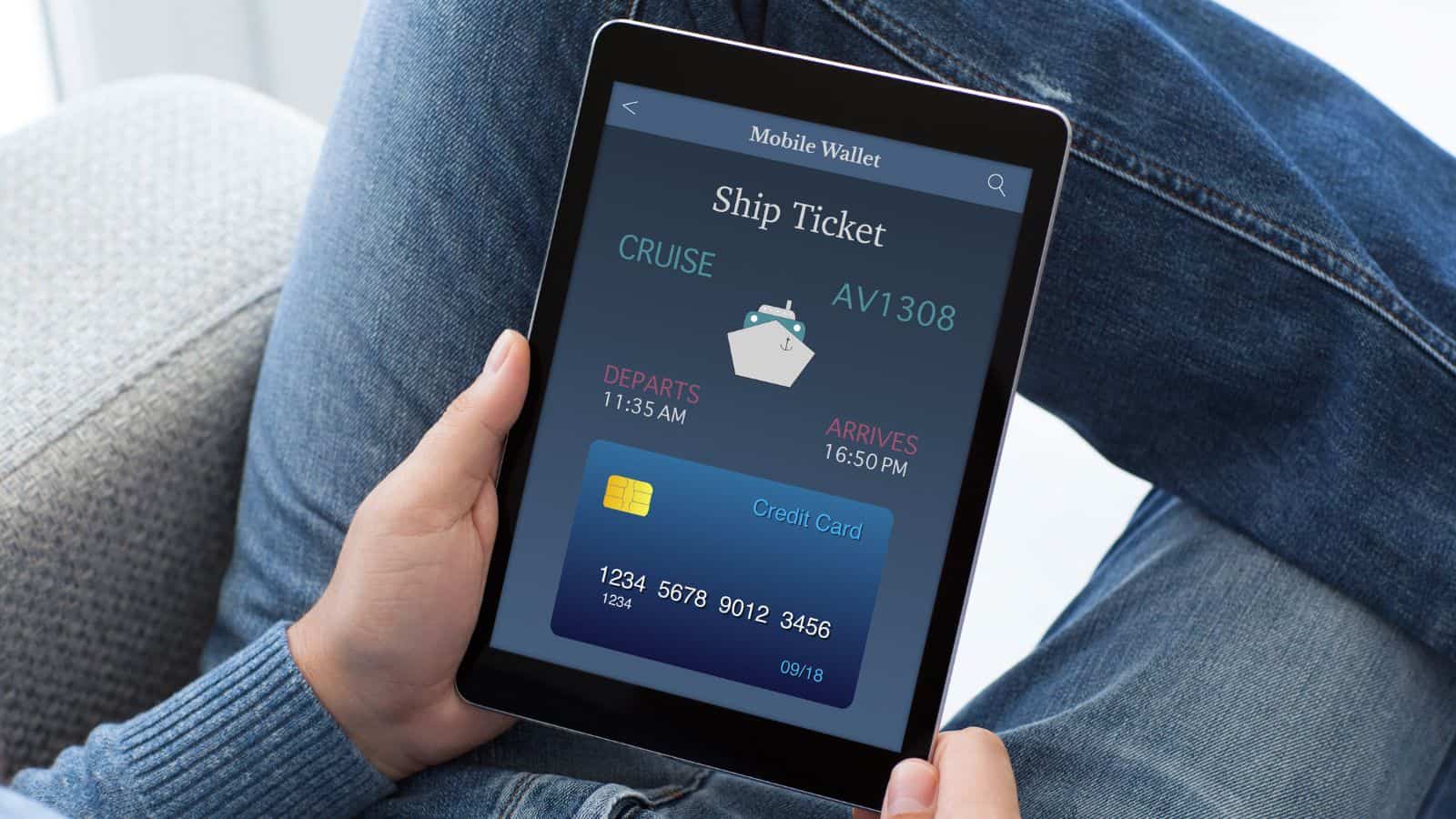 A person holds a tablet displaying a mobile wallet app with a digital ship ticket for cruise AV1308, showing departure at 11:35 AM, arrival at 16:50 PM, and a credit card image below the ticket details.