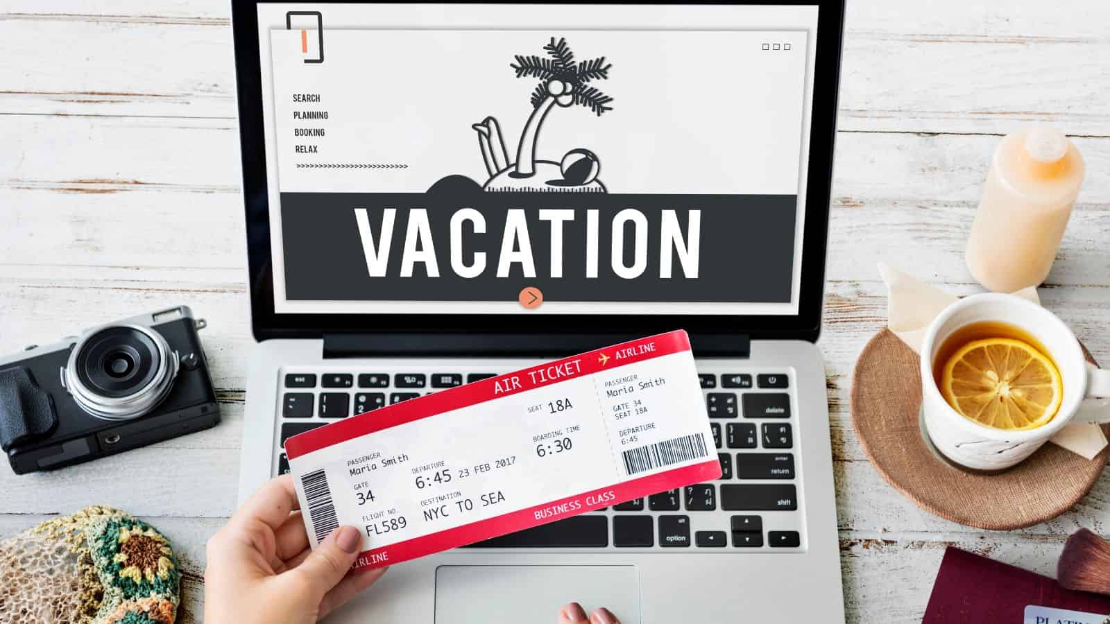 A hand holds a plane ticket in front of a laptop displaying "VACATION" on the screen, ready to book with airline points and discover new travel tips.
