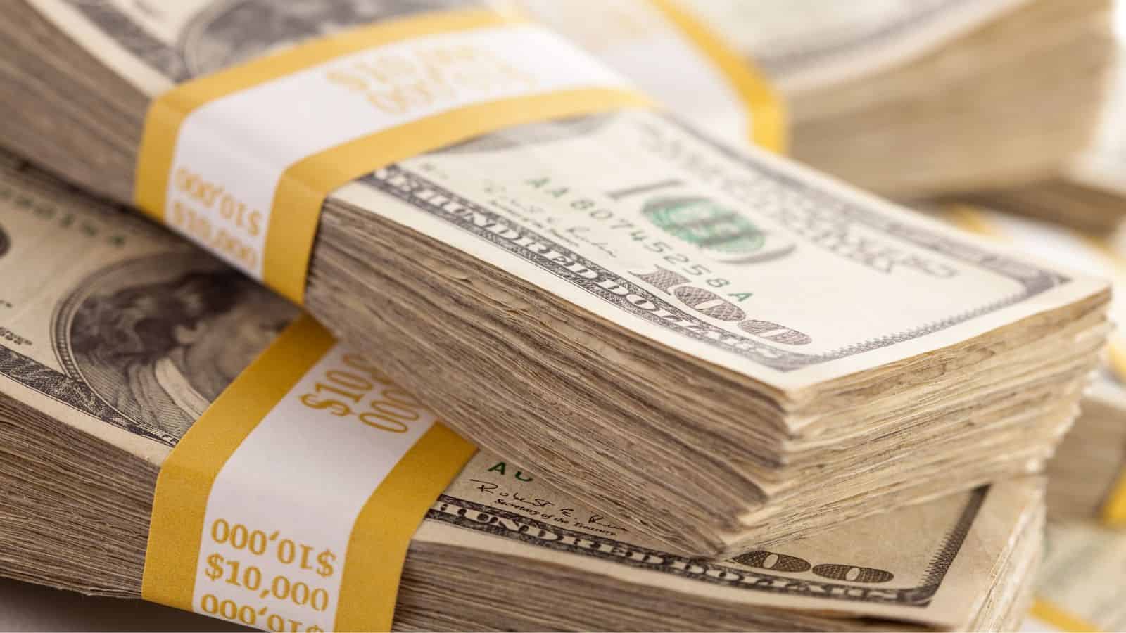 Stacks of $10,000 bundles of U.S. hundred-dollar bills arranged closely together.