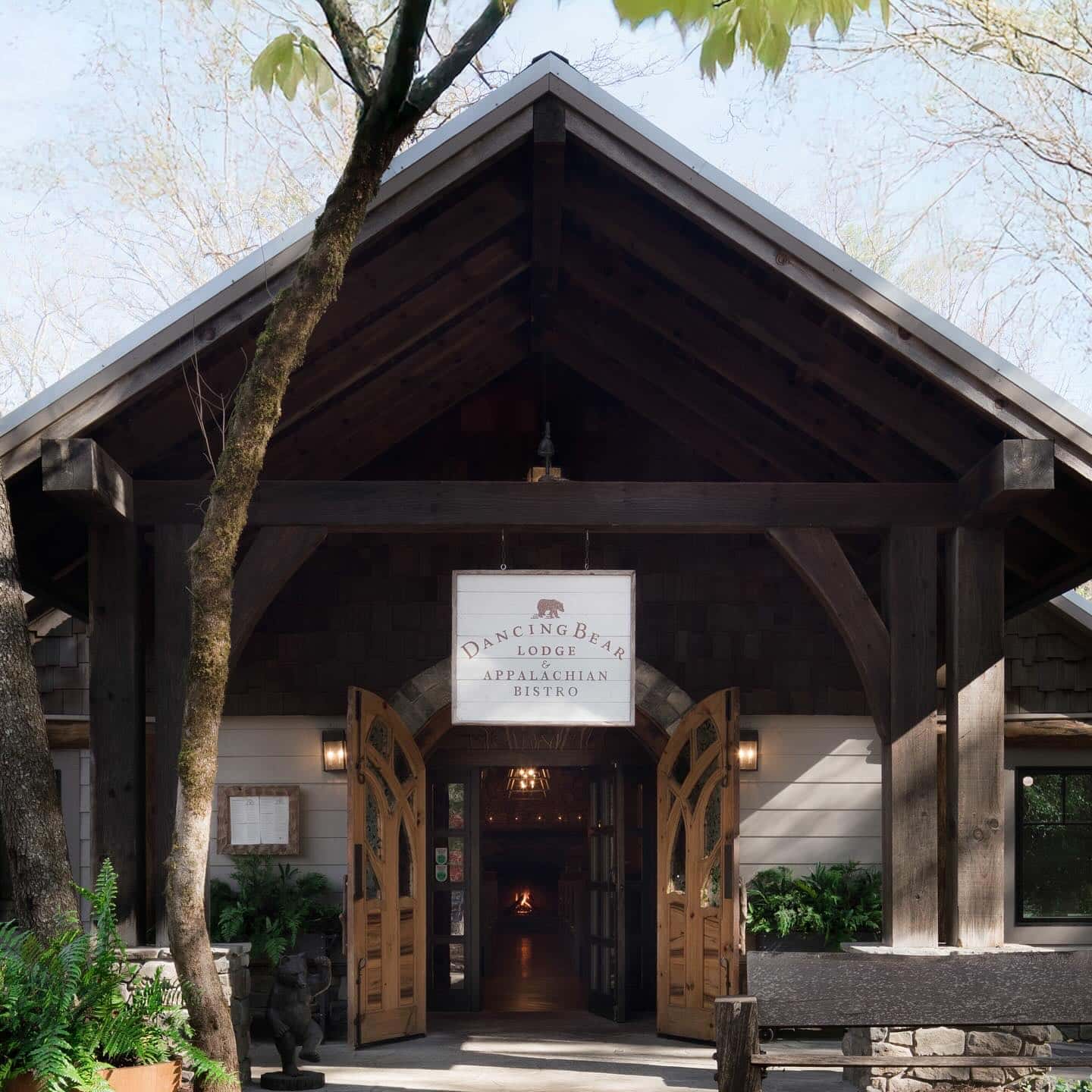 A building with a sign and a tree, perfect for those seeking the best mountain getaways.