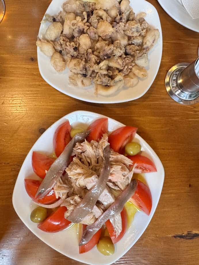 Savor plates of fresh food: crispy fried calamari, and a tomato salad with tuna, anchovies, and olives—just like you’d find in Barcelona markets.