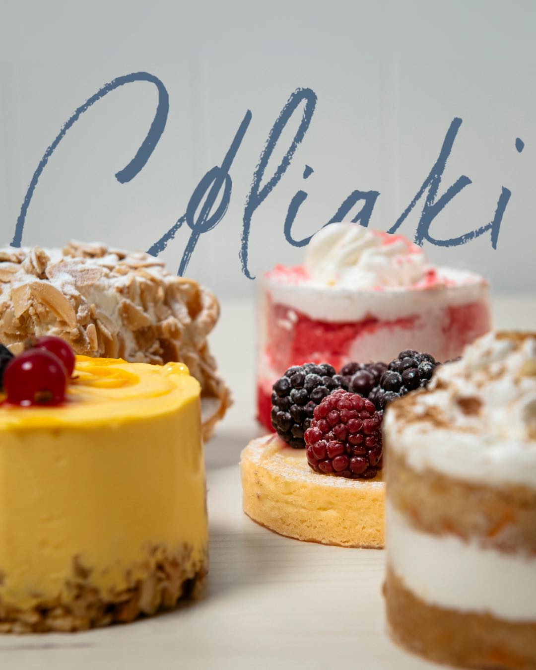Assorted gluten-free cakes topped with berries on a light surface, with "Celiaki" written in the background—perfect for anyone seeking Gluten Free Barcelona delights.