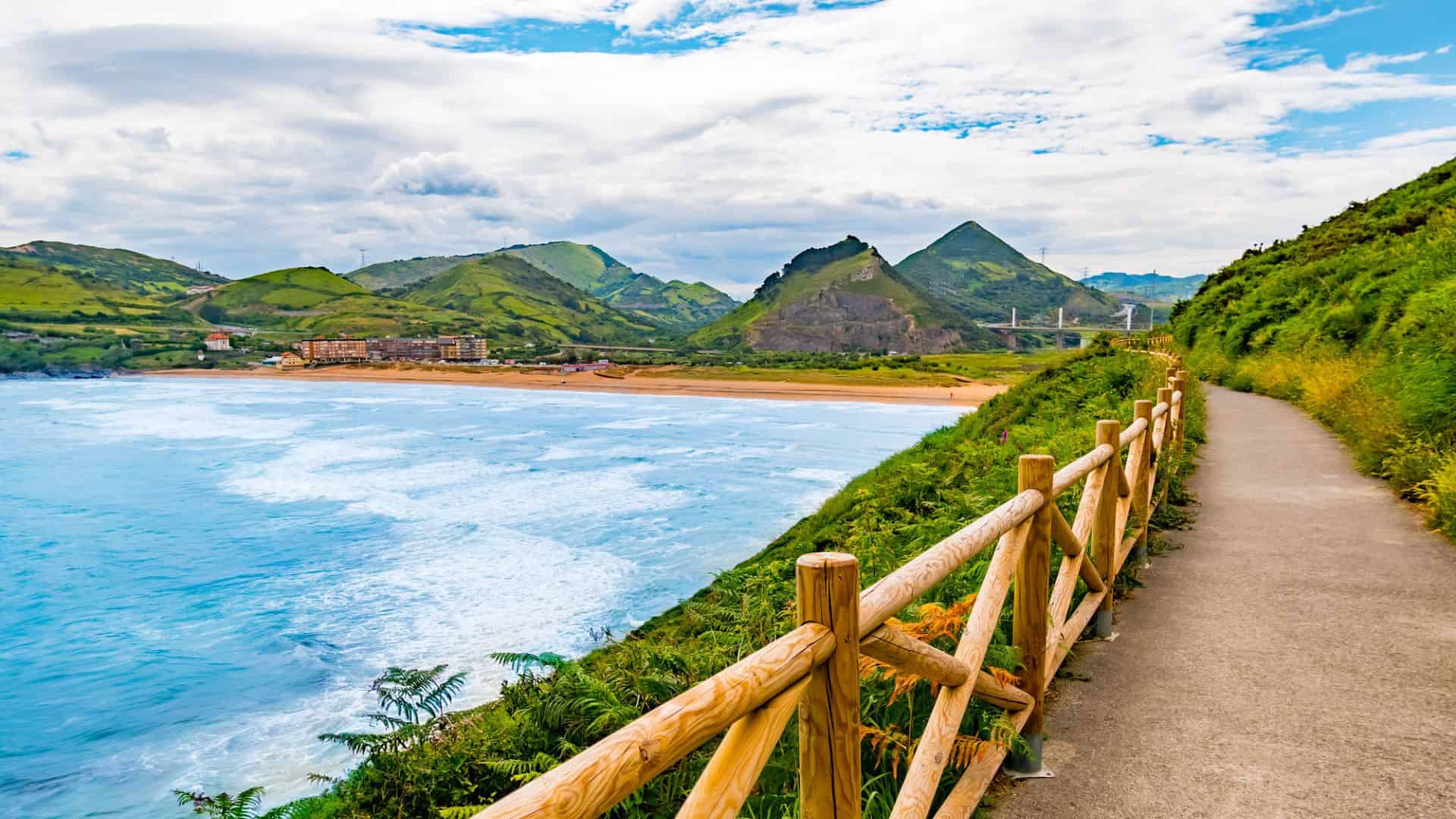 A wooden fence next to a body of water.