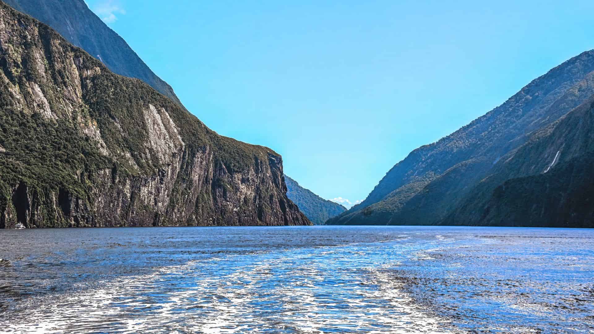 A body of water with mountains in the background.