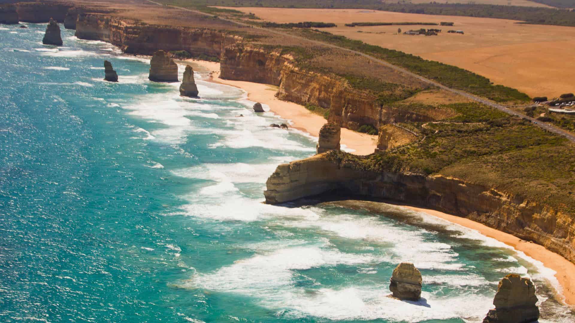 Aerial view of the Twelve Apostles rock formations along Australia’s scenic coastline with turquoise waves.