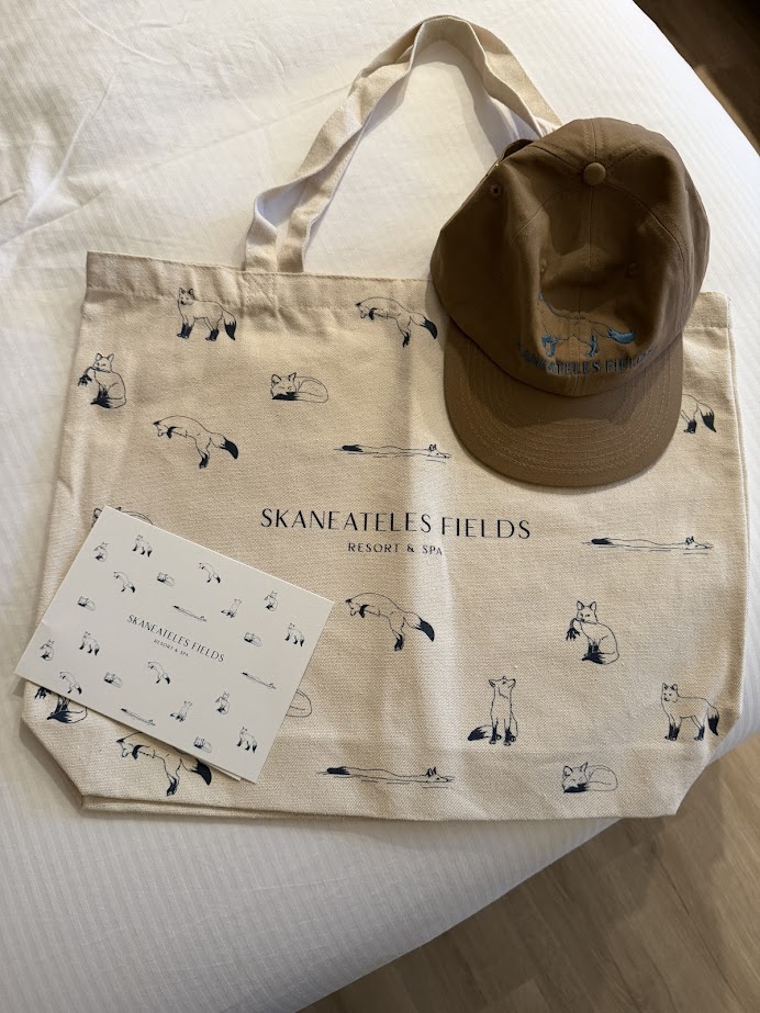 Tote bag, cap, and card from Skaneateles Fields Resort & Spa in the Finger Lakes, each adorned with charming fox illustrations.