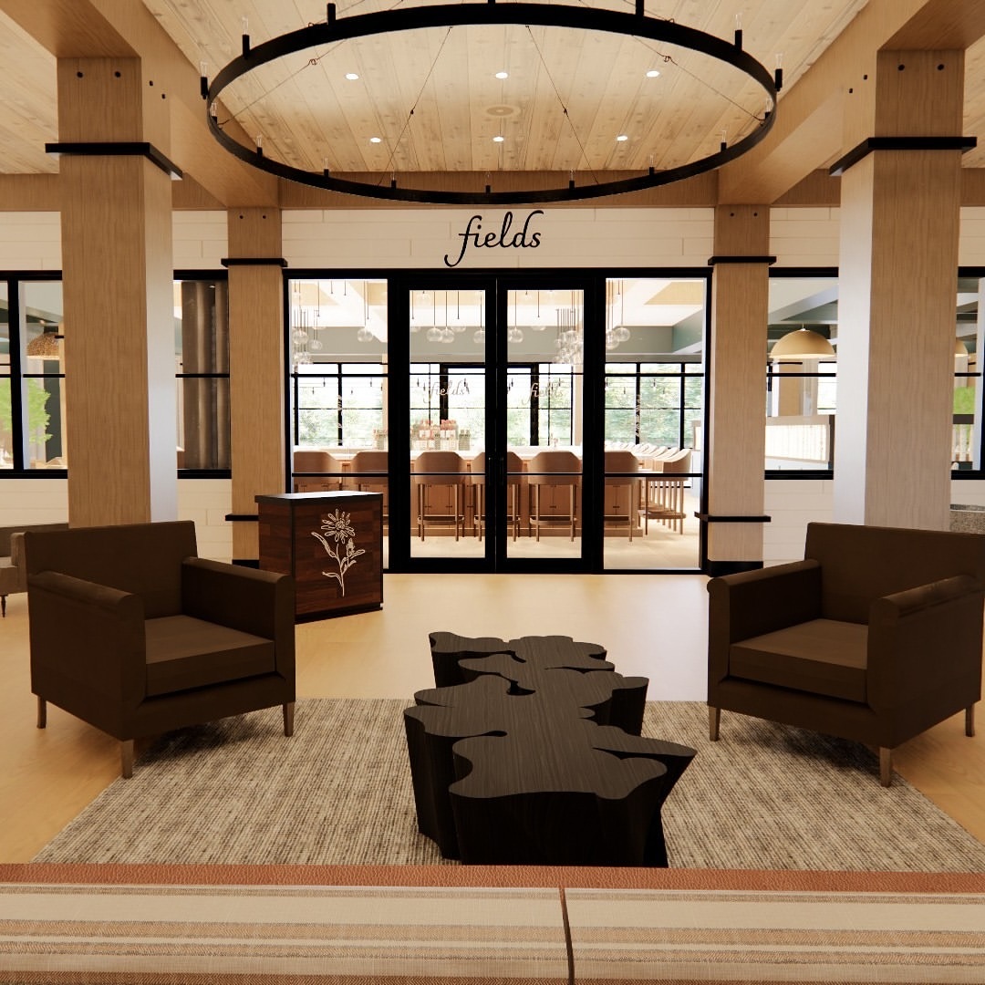 A modern lobby at Skaneateles Fields Resort features armchairs, tree-shaped tables, and a sign that reads "fields" above glass doors—inviting guests to unwind in the heart of the Finger Lakes.