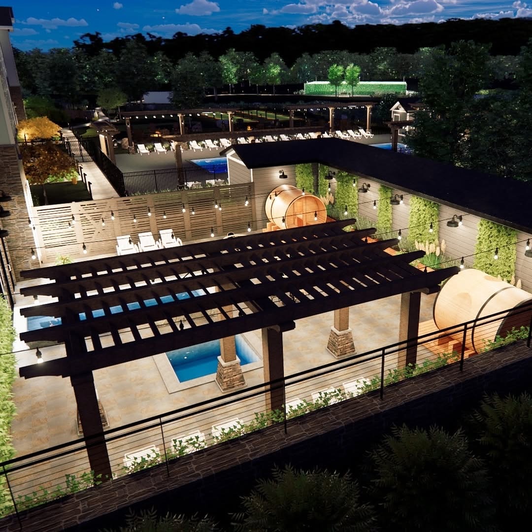 Rooftop patio at night with pergola, pool, barrel saunas, greenery, and illuminated seating areas—an inviting oasis at Skaneateles Fields Resort in the Finger Lakes for a spa-inspired escape under the stars.