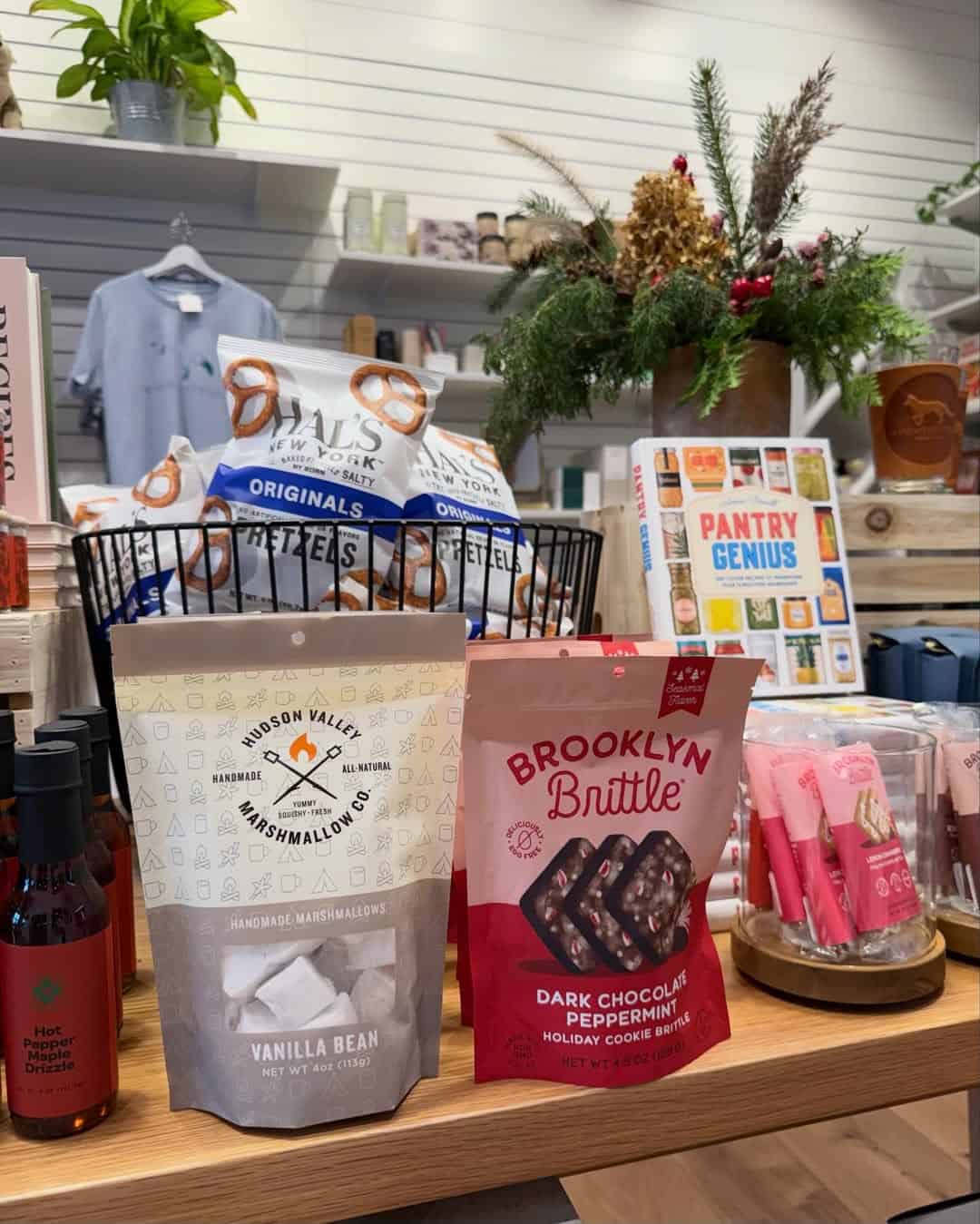 Gift shop display at Skaneateles Fields Resort with snacks like marshmallows and peppermint brittle, plus holiday-themed decorations. A perfect treat after a relaxing day at the Finger Lakes spa.