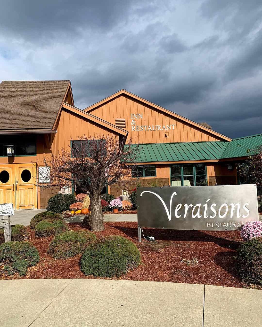 Veraissons Restaurant exterior with landscaped bushes and cloudy sky in the background, nestled among renowned Finger Lakes Wineries with Lodging.