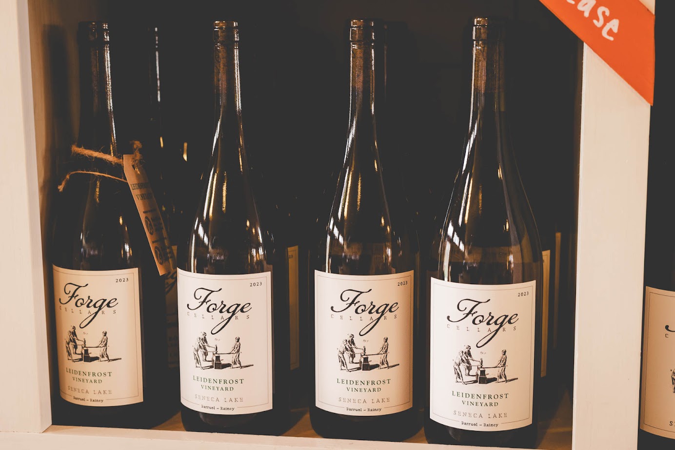 Four bottles of Forge wine labeled "Leidenfrost Vineyard" displayed on a shelf—a showcase from one of the best wineries in Finger Lakes.