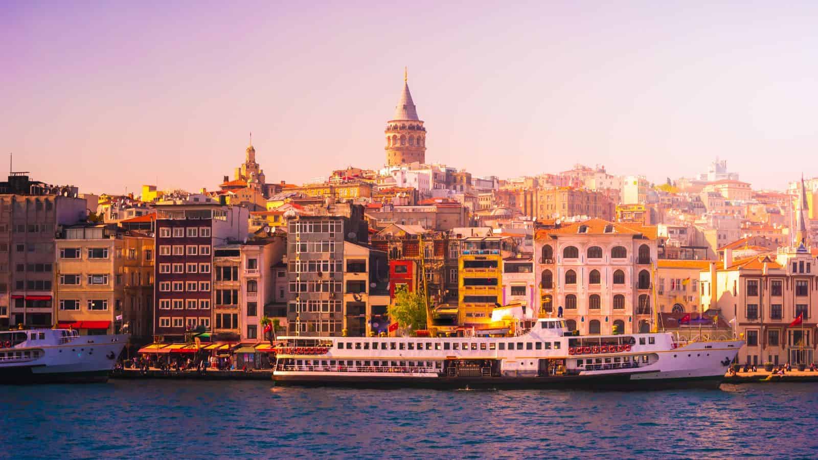 Colorful buildings and boats line the waterfront, with the Galata Tower rising in the background&mdash;one of those places where history is impossible to ignore in Istanbul, Turkey.