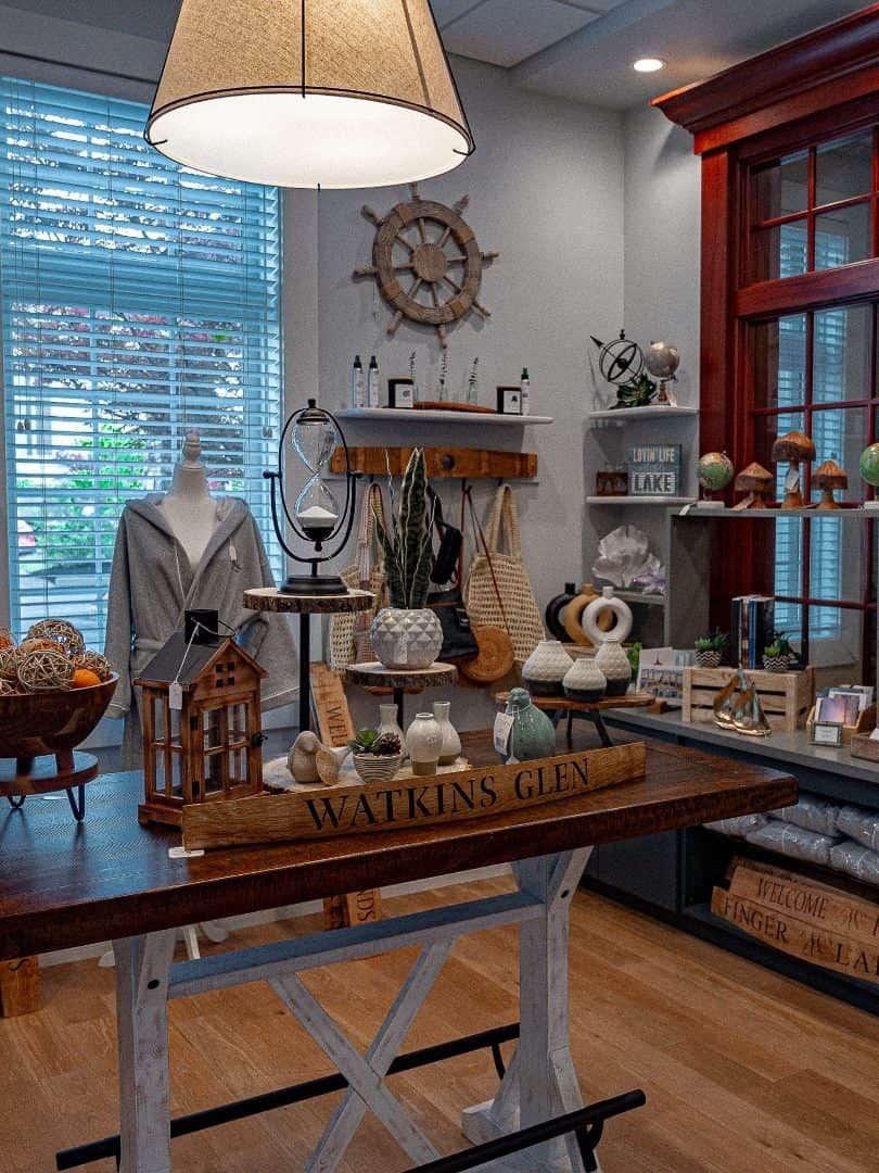 A cozy gift shop interior with wooden decor, a Watkins Glen sign, and nautical-themed items on display—a charming stop while exploring the Best Places to Stay in Finger Lakes Near Wineries.