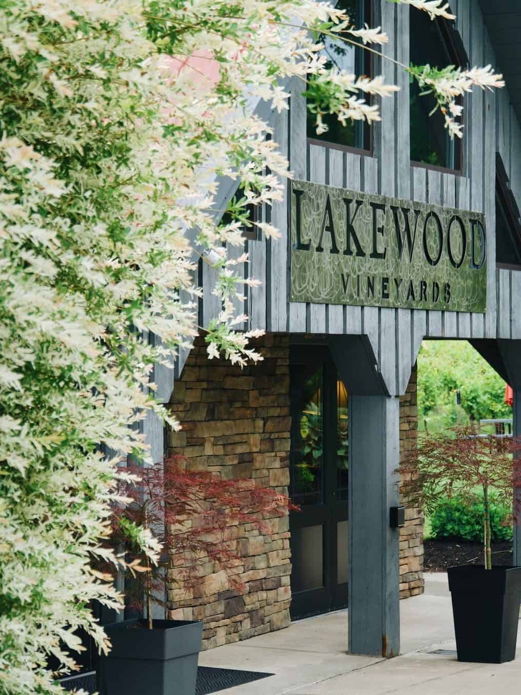 Lakewood Vineyards building exterior with stone walls, large sign, and potted plants by the entrance—one of the Best Places to Stay in Finger Lakes Near Wineries for wine lovers seeking charm and convenience.