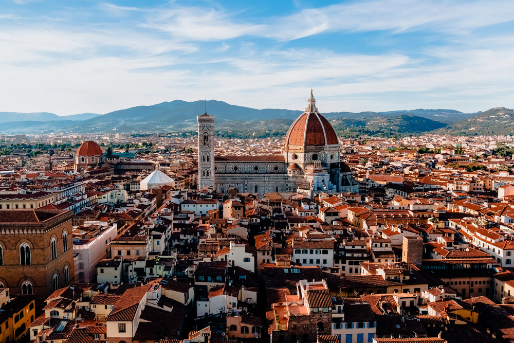 Florence cityscape with the Cathedral of Santa Maria del Fiore and red rooftops under a blue sky—an unforgettable destination to explore when you travel with teens.