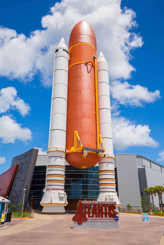 A space shuttle rocket display stands tall outside the Atlantis exhibit at Kennedy Space Center, making it one of the top things to do in Orlando with kids.