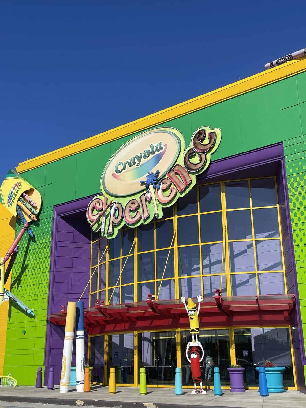 Colorful Crayola Experience building with large crayons and mascot statues at the entrance on a sunny day—one of the top things to do in Orlando with kids.