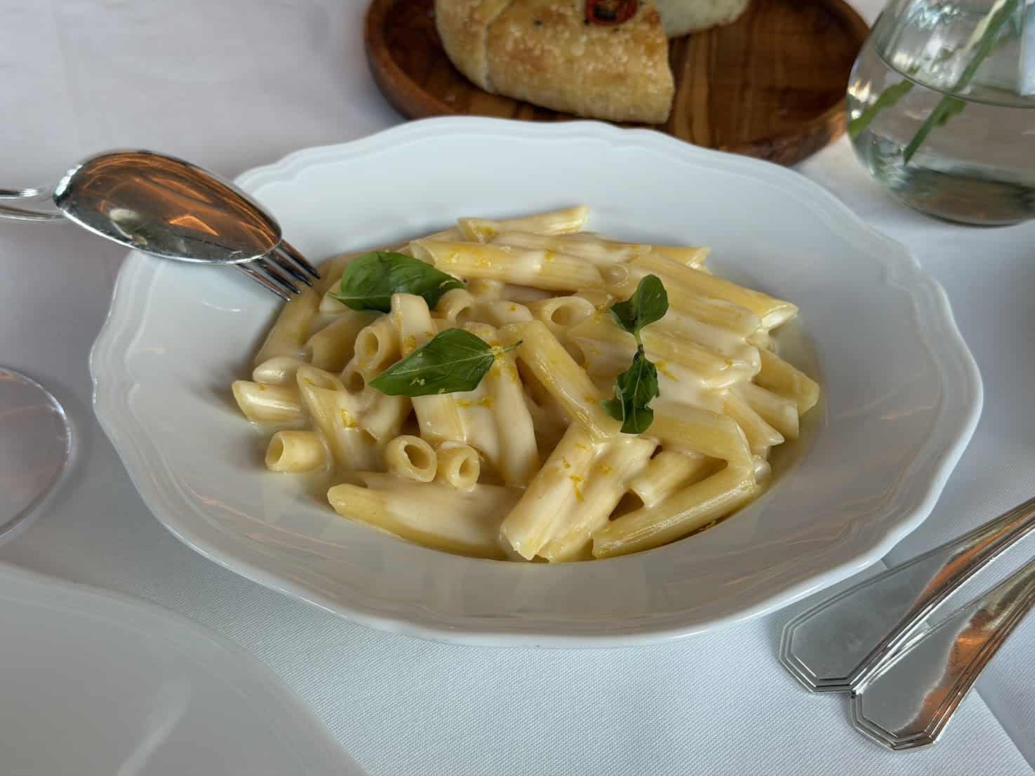 Penne pasta in a creamy lemon sauce topped with basil leaves, as seen in our Seia Miami review.